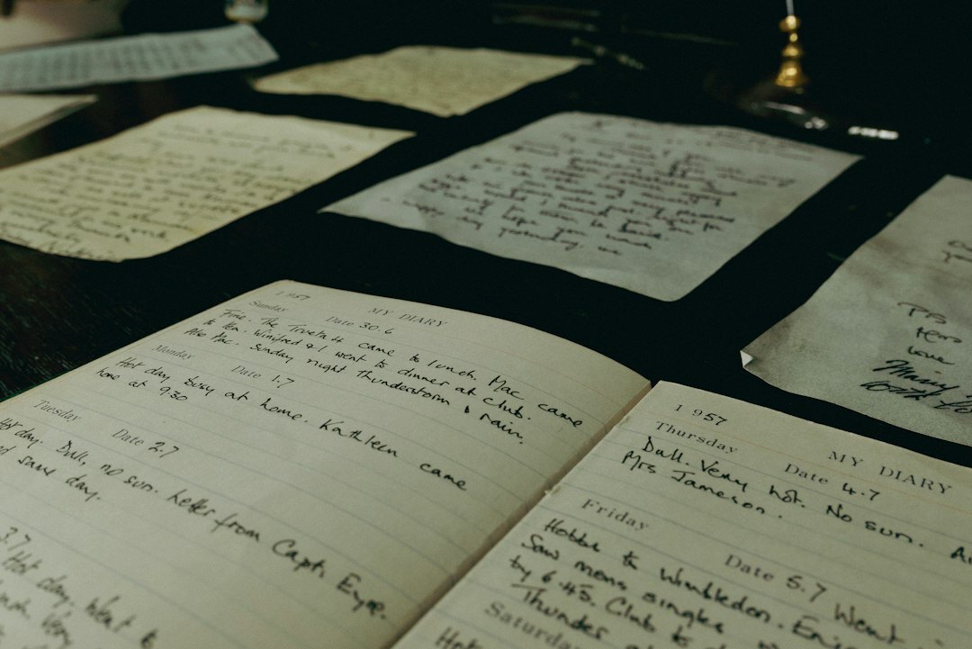 Close-up of handwritten research notes and archival documents on a desk